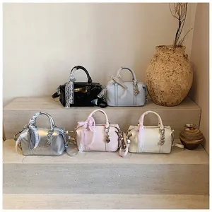 Five assorted Boston bags displayed on stone steps with decorative scarves and heart charms