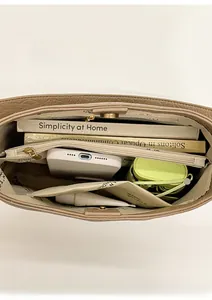 Vertical view of khaki tote bag interior showing large compartments and pocket dividers