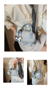 Detail of light blue lychee pattern leather bowling bag with cute horse pendant charm