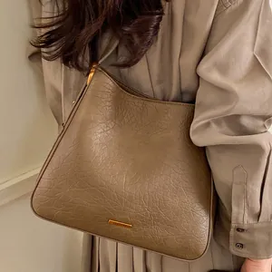 Classic dark tan crinkled leather tote bag with elegant golden hardware and hobo style