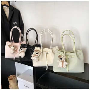 Detail view of woven texture tote bags in pink, black, beige and green with dog charms