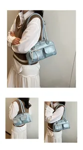Detail of light blue PU leather boston bag with pearl bow charm and double front pockets