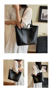 Detailed macro view of the black leather tote bag with elegant golden logo printing