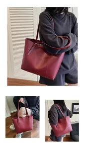 Three-way view of a large wine red tote bag with slim shoulder straps for daily commute