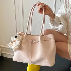 Pink woven texture shoulder tote bag with plush bear charm for stylish commuting