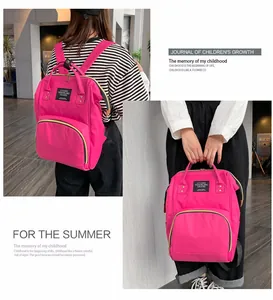 Detail of waterproof rose red mommy backpack with dual handles and adjustable shoulder straps