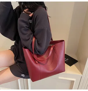 Close-up of burgundy leather tote bag showing large capacity and soft polished texture
