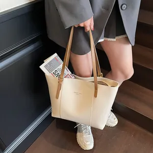Minimalist cream tote bag with brown straps and spacious interior for daily fashion
