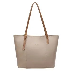 Beige faux leather tote bag with brown straps and Fashion Trend Soulfu gold lettering