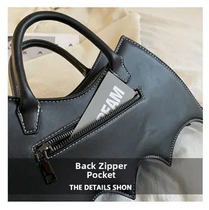 Detail view of the back hidden zipper pocket on this bat-shaped black PU leather handbag