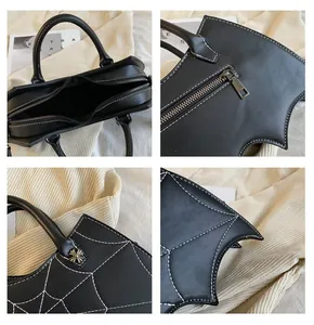 Detail of bat wing handbag with white spider web stitching and ornate metal rivets