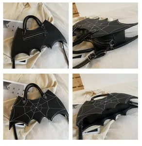Detail of bat-shaped PU leather bag with spider web stitching and cross rivet accents