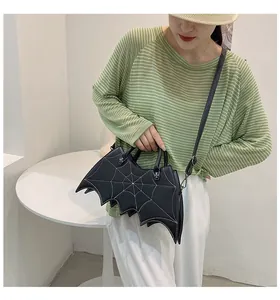 Detail of bat wing handbag with white spider web stitching and metal spider zipper pull