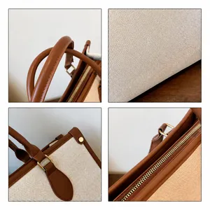 Detail view of canvas tote bag with leather trim, metal zipper and PARI lettering