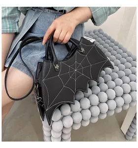 Detail showing bat-shaped bag with spider web stitching and adjustable shoulder strap