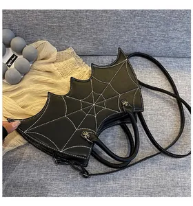 Detail showing the bat-shaped black PU leather bag with white spider web stitching