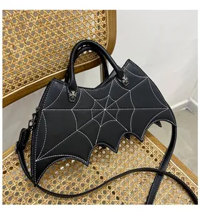Detail of bat-shaped PU handbag with white spider web stitching and silver star studs