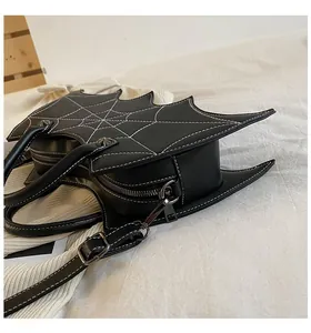 Detail of bat-wing shaped handbag with spider web stitching and zipper hardware