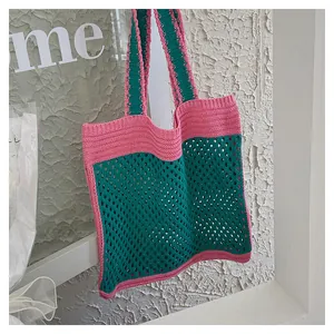 Close-up of handmade knit tote bag with pink and green contrast hollow mesh design