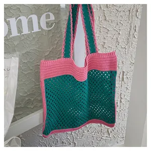 Detail of handmade crochet tote bag featuring pink and green contrast knit pattern