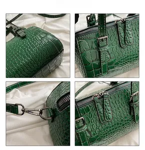 Detailed views of dark green faux crocodile leather bag with silver zippers and hardware