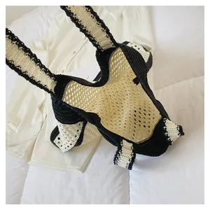 Detailed top view showing the hollow knit texture and black handle of this tote bag