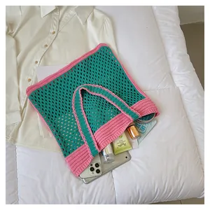 Detail view showing storage capacity of a green and pink crochet knit tote bag