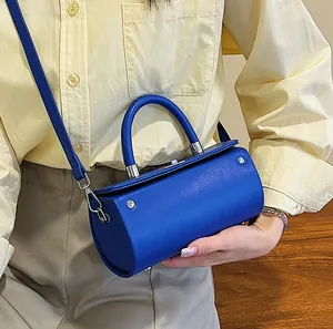 Fashionable Klein blue cylindrical bucket bag for women, worn as a crossbody or handbag