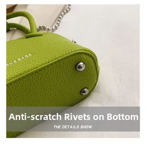 Close-up of bright green lychee textured bag with silver protective metal studs on base