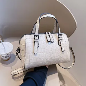 Beige crocodile embossed leather handbag with dual zippers and adjustable shoulder strap
