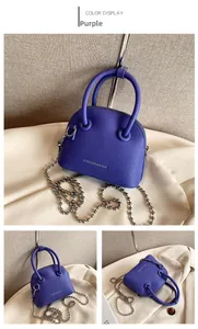 Detail of purple lychee texture crossbody bag with silver bead chain and round handles