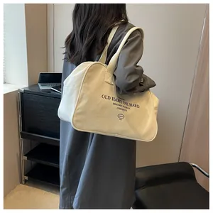 Detailed back view of a large cream canvas tote bag with black slogan lettering print