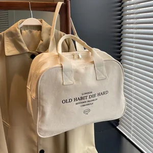 Minimalist beige canvas tote bag with retro black text and dual zipper closure for women