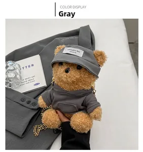 Detail of cute grey teddy bear plush bag with chain strap and hoodie accessory
