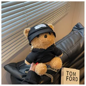 Detail of cute brown teddy bear plush bag with a black hoodie and golden chain strap