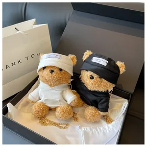 Detail view of cute plush bear shoulder bags with gold chains in premium gift box packing