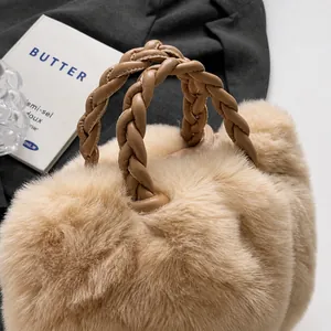 Close-up of fluffy faux fur tote bag with a soft woven leather handle in apricot hue