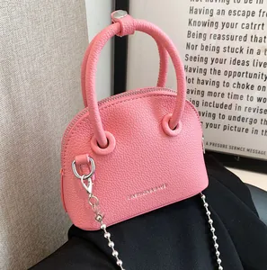 Pink lychee texture shell cross-body bag with silver ball chain and top handle