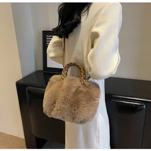 Detail of camel faux fur tote with a brown braided leather handle and pleated cloud design