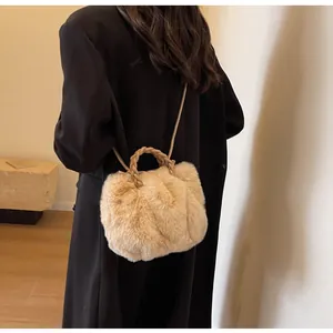 Detail of plush beige tote bag featuring woven leather handles and soft faux fur texture