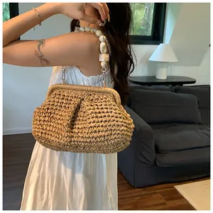 Detail of hand-woven straw bag featuring luxury marble resin bead handle in summer style