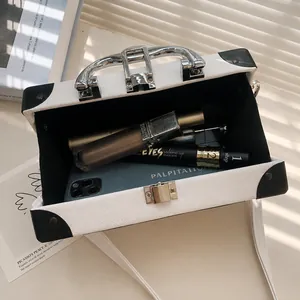 Internal view showing capacity of the vintage radio box bag with phone and cosmetics