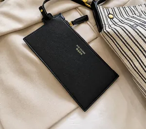 Close-up of black PU leather zipper pouch accessory with metallic hook and strap