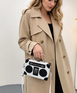 Creative radio shaped shoulder bag featuring retro black and white design with silver handle