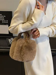 Brown fluffy faux fur tote bag with a woven handle shown in a stylish lifestyle setting