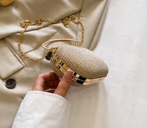Detailed side view of champagne gold glitter evening bag with chain and metal handle