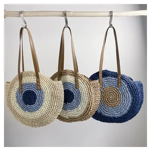Detailed texture of handcrafted circular woven straw tote bags in various color patterns