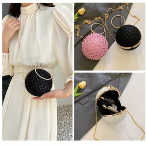 Detailed views of the spherical evening bag with sequins and round metal handle