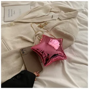 Chic star-shaped crossbody bag in metallic rose pink finish with a slim gold chain strap