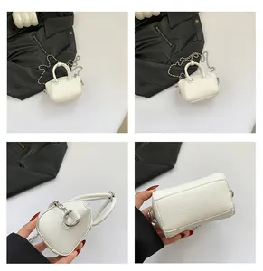 Multiple views of a mini white textured leather handbag with a silver bead chain strap